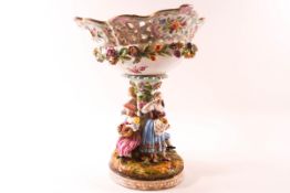 A 19th century German porcelain table centre with pierced basket encrusted with flowers supported