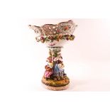 A 19th century German porcelain table centre with pierced basket encrusted with flowers supported