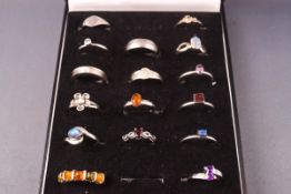 A collection of sixteen sterling silver dress rings consisting of signet and gemset designs.