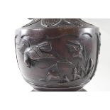 A late 19th/early 20th century Japanese bronze two handled vase, decorated with birds in relief,