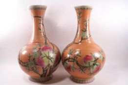 A pair of Chinese porcelain vases painted in enamels with flowering and fruiting peach branches,
