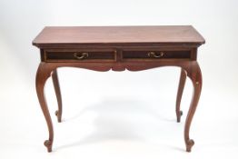 A mahogany side table with two frieze drawers, shaped apron and cabriole legs,