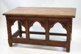 An oak Church communion table with gothic style triple arched front, 78cm high x 144cm wide x 76.