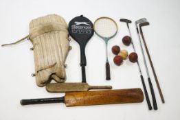 Various cricket items, including balls, a bat and knee pads,