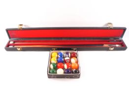 A set of small size pool balls and a cased John Spencer snooker cue