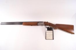 A Rizzini under and over 12g shotgun, Serial No 3346, and slip.