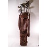 Various golf clubs, including three Spalding woods and others by T Stewart,