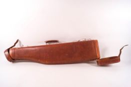 A leather leg of mutton gun case with green baize lining,