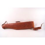 A leather leg of mutton gun case with green baize lining,