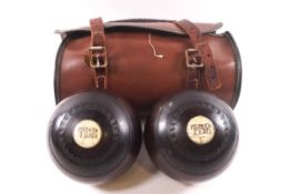 Two Victorian bowling woods in leather case and a set of four bowling woods and shoes