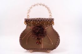 A 1960's handbag lamp with applied trim, beaded drops and handle,