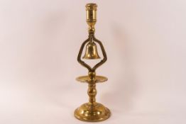 A brass candlestick with a bell above the drip pan on flared domed foot, 31.