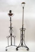 A Victorian wrought iron and brass telescopic oil lamp, 159cm high, and a further telescopic lamp,