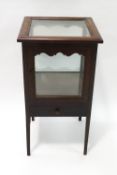 An Edwardian mahogany framed display cabinet with glazed top and sides and drawer to base,
