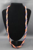 A multi strand twisted coral and sodalite bead necklace with goldplated clasp. 89.