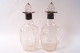 A pair of silver mounted cut glass decanters and stoppers, maker's mark 'SAC', Sheffield 1925, 26.