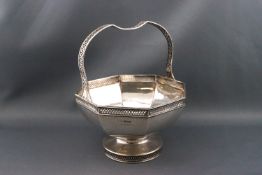 A silver pedestal basket, the octagonal bowl on a round foot and with a pierced handle,