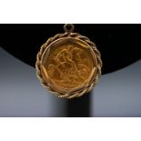 A gold half sovereign dated 1909 in a polished and rope mount 9stamped 9ct) suspended from a rope