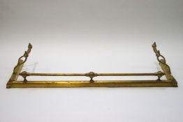 A Victorian brass fender of ball and rail design,