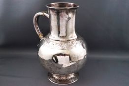 A Victorian Britannia silver water jug, with moulded lip to the cylindrical neck,