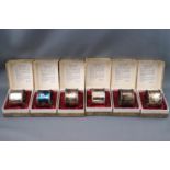A set of six silver napkin rings each in original box, each engraved on the inside,