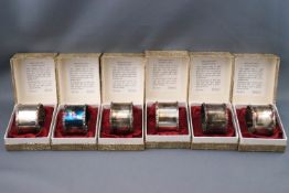 A set of six silver napkin rings each in original box, each engraved on the inside,
