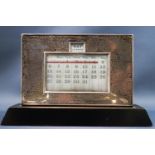 A 1930's silver mounted desk calendar with presentation inscription "J M Wills,