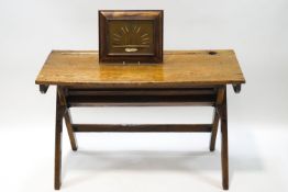 An early 20th century oak twin school desk, 64cm high x 100cm wide x 43cm deep,