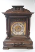 A late 19th century oak cased chiming mantel clock by Junghams, key and pendulum,