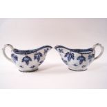 A pair of late 18th century pearlware moulded sauce boats, painted in blue with flowers and insects,