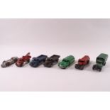 Seven 1940s/50s Dinky die-cast vehicles: two Austins trucks, pick up truck, two petrol carriers,