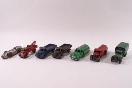 Seven 1940s/50s Dinky die-cast vehicles: two Austins trucks, pick up truck, two petrol carriers,