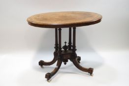 A Victorian burr walnut loo table, the top with decorative inlay,