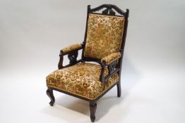 An Edwardian mahogany armchair with carved crest rail and side supports on cabriole legs