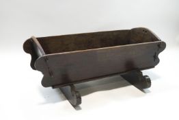 A Welsh elm crib, inscribed 1731, on scroll end rockers,