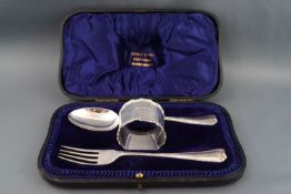 A silver Christening fork, spoon and napkin ring, Sheffield 1909 by Atkin Bros, 98g,