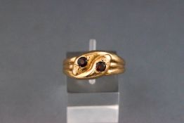 A 9ct gold and garnet ring in the form of a pair of entwined snakes, London 1971, size R1/2,