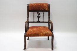 An Edwardian mahogany nursing chair with Classical carved splat,