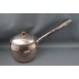 A silver saucepan and cover, with straight tapering handle, 14cm high, London 1910,