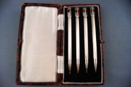 A set of four enamelled bridge pencils, stamped "Sterling Silver Made In England",