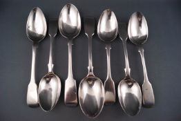 Seven assorted silver fiddle pattern dessert spoons, various dates and makers,