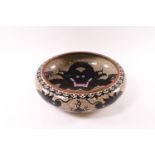 A Chinese cloisonne enamel bowl with a black dragon to the centre and further dragons to the