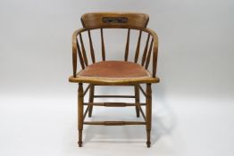 An early 20th century elm stick back chair with carved inscription,