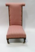 A Victorian mahogany pre dieu chair on ceramic casters,
