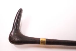 A wooden walking stick with brass collar,