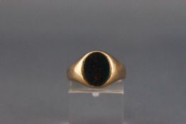 A 9ct gold and oval bloodstone signet ring, size M, 5.8g gross.