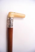 A malacca walking stick with ivory handle and silver collar