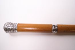 A heavy malacca cane with embossed silver knop and strap silver band
