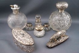 An early 20th century cut glass globular scent bottle with embossed silver top, 12.