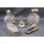 An early 20th century cut glass globular scent bottle with embossed silver top, 12.